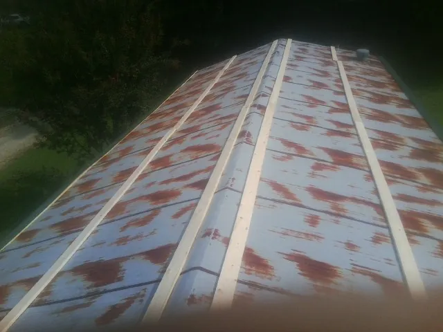 Rusted metal roof panels with new wood purlins before replacement — Storm Damage Roof Repair in Three Bridges by Roofing Brothers